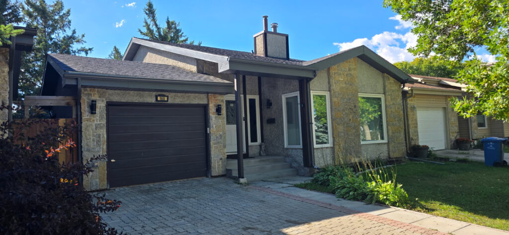 Pre-finished brown aluminum soffit and fascia with new asphalt shingles on a Winnipeg home — Trudel Roofing